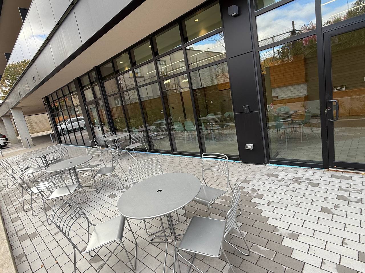 Members patio with outdoor seating against floor-to-ceiling windows