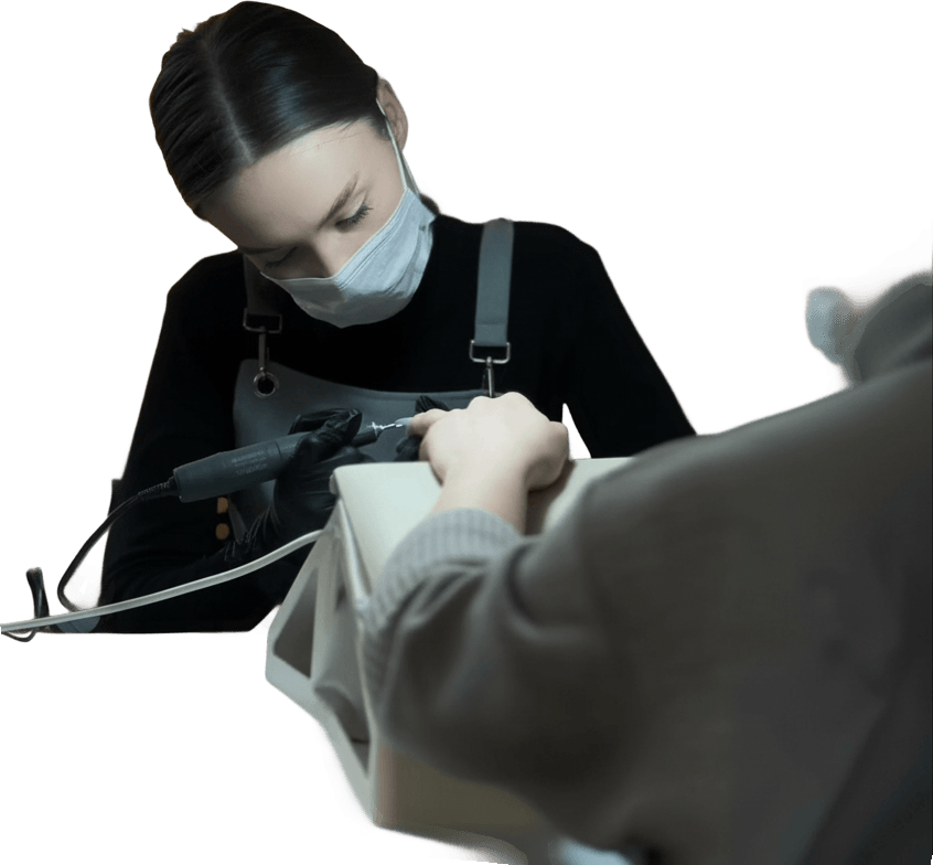 A nail technician concentrating on a client's manicure in her Industry Suite
